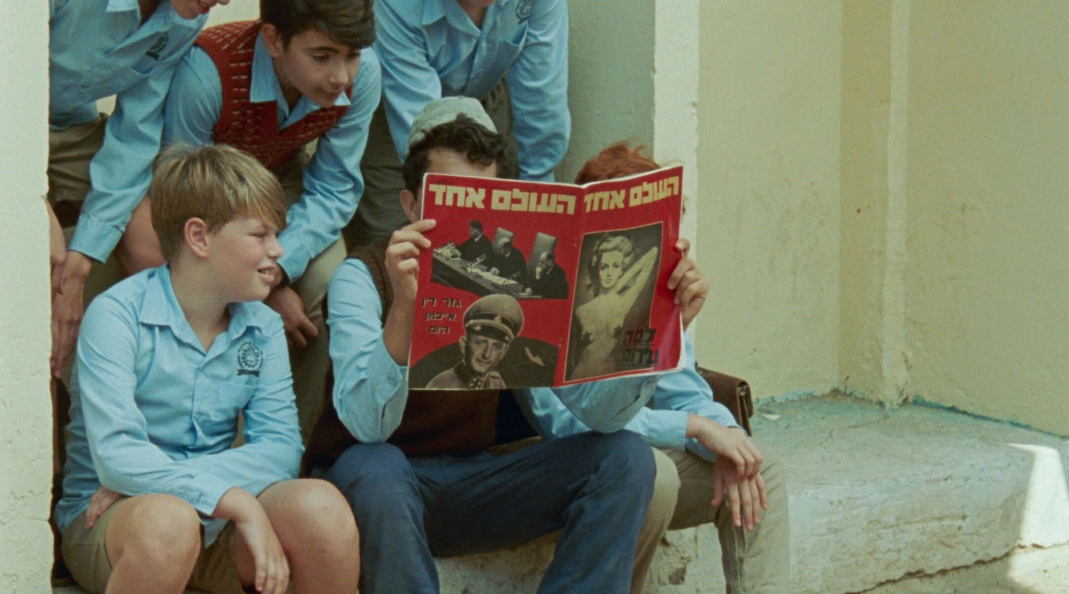 A group of schoolchildren read a news magazine in "June Zero," a new film depicting the Eichmann trial's reception in Israel. (Courtesy Cohen Media Group)