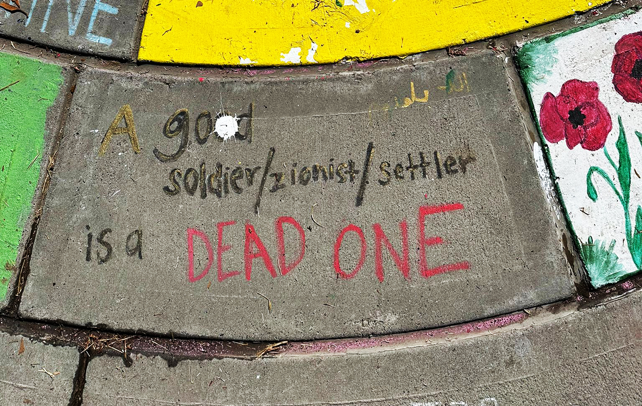 "A good soldier/zionist/settler is a DEAD ONE," reads sidewalk graffiti near the UC Davis pro-Palestinian encampment, which has since been disbanded. (Mily Ron)