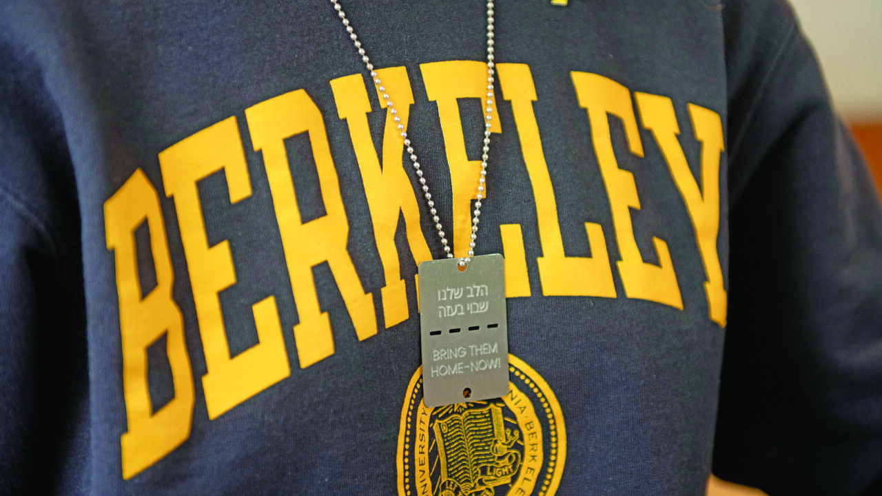 A student at Berkeley Hillel wears a “Bring Them Home – Now!” dog tag in March 2024 in support of the hostages taken by Hamas. (Aaron Levy-Wolins/J. Staff)