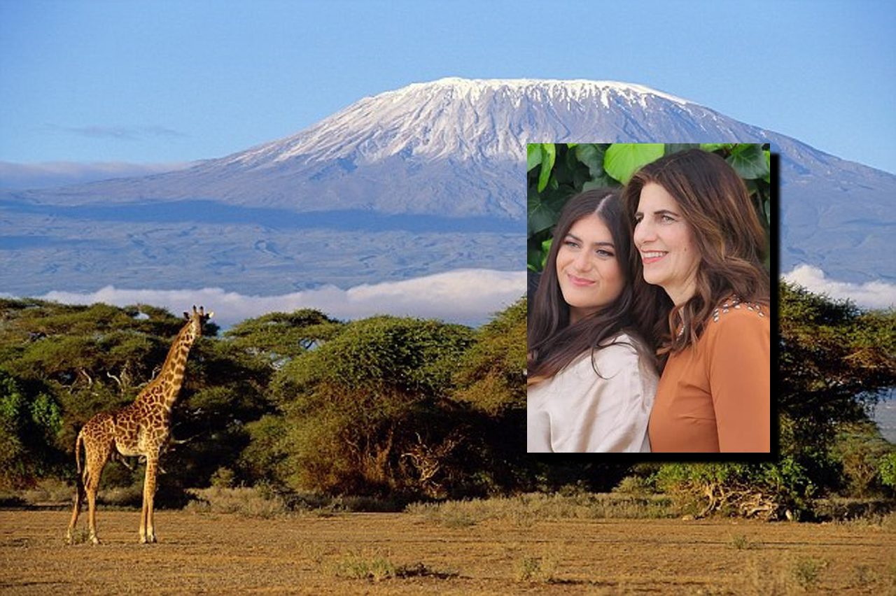a small photo of Miriam and Brachie inset within a larger photo of a giraffe standing near a very tall mountain