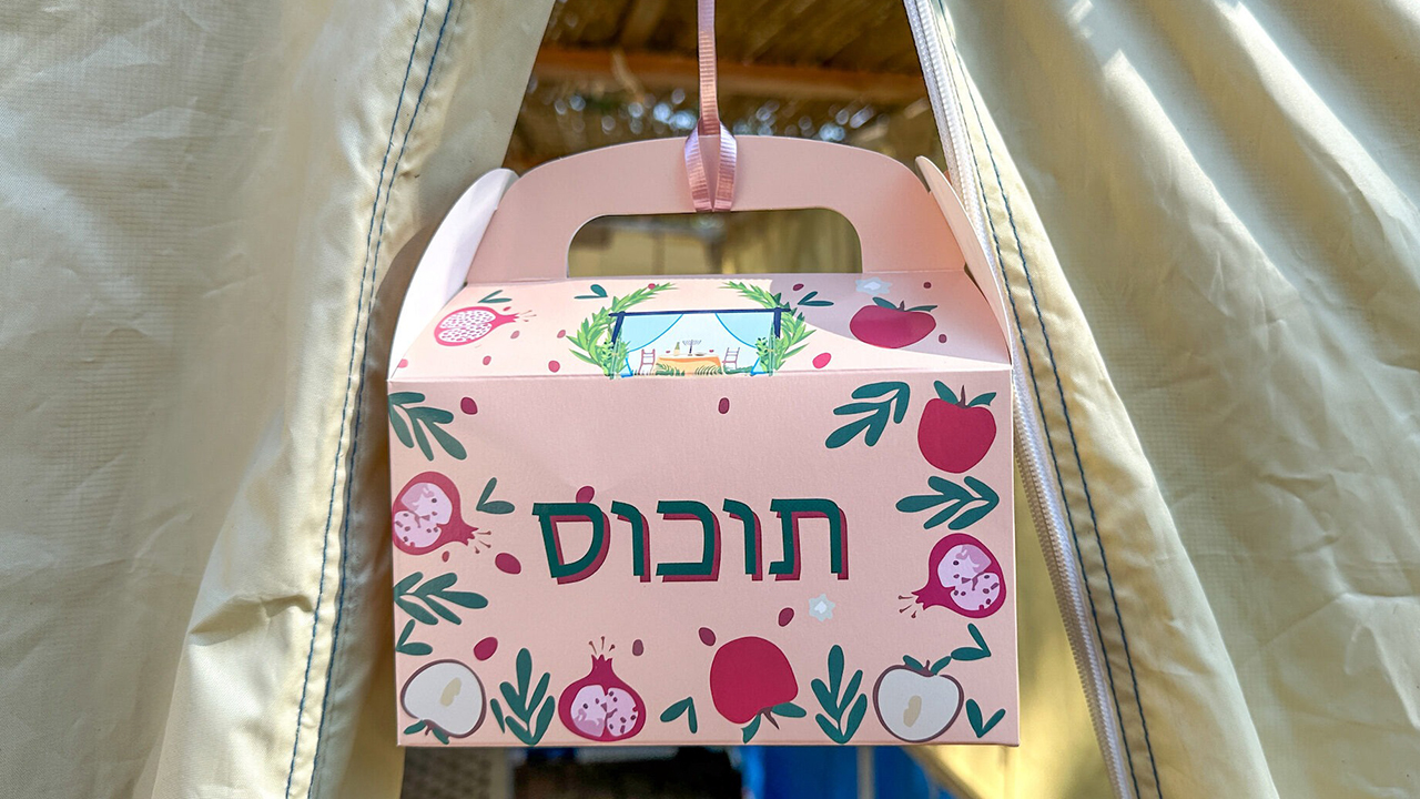 one of the boxes hangs from the roof of a sukkah