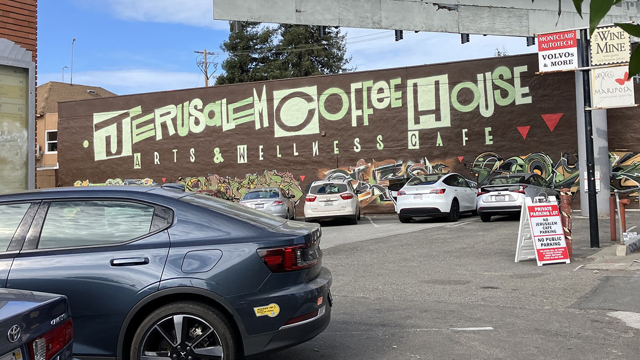 an exterior wall says "Jerusalem Coffee House: Arts and Wellness Cafe"