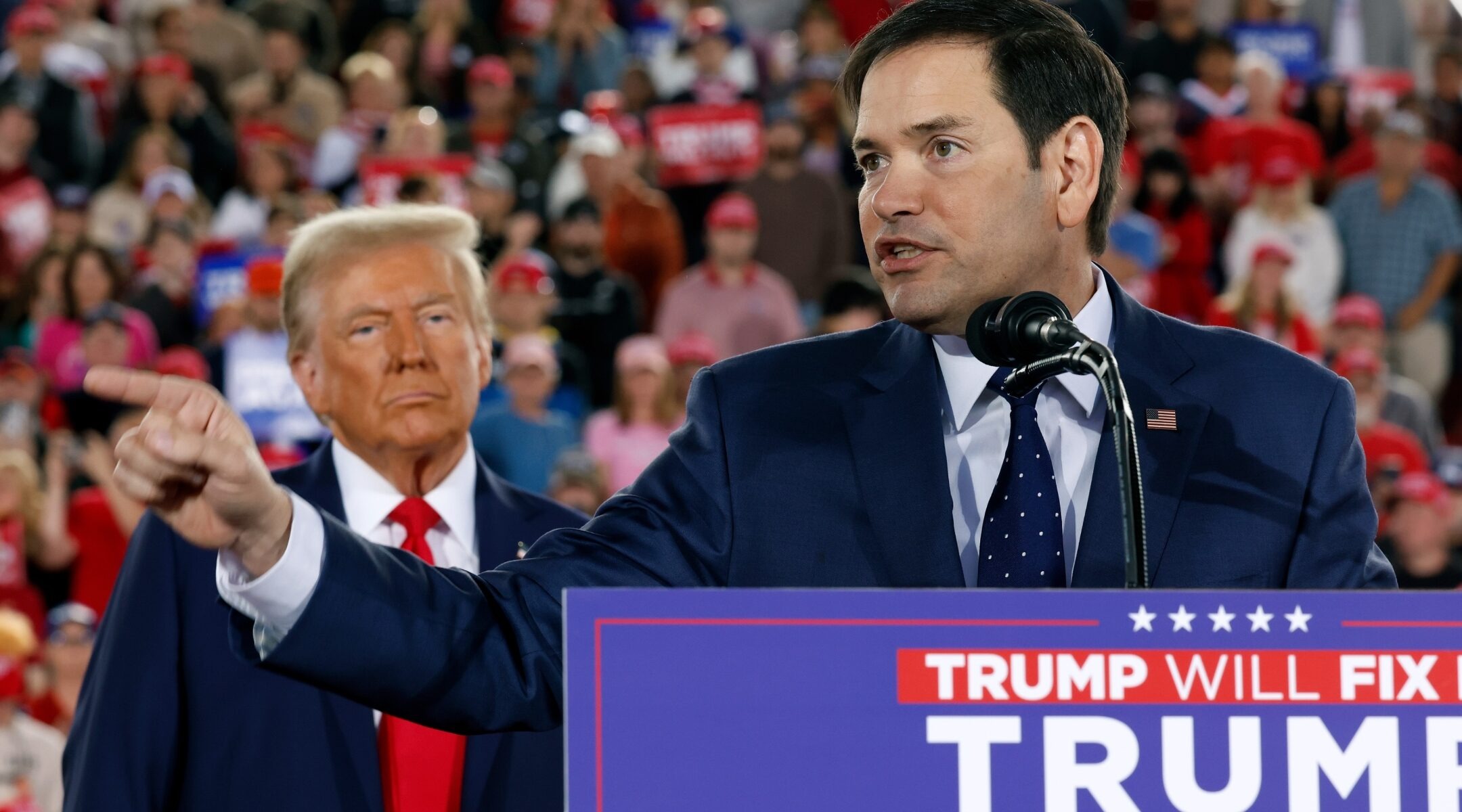 Rubio speaks at a lectern with Trump standing next to him