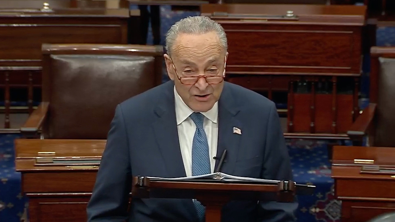 Schumer speaks at a lectern in the Senate chamber