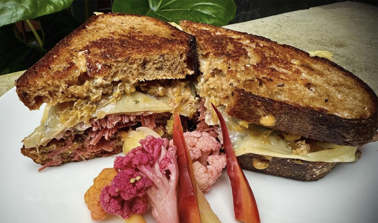 a pastrami sandwich and pickled cauliflower on a plate
