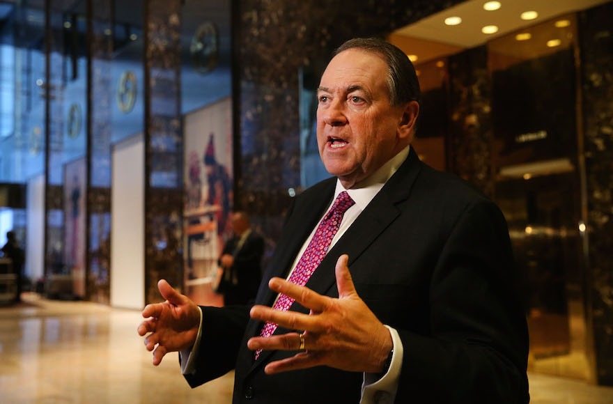 Huckabee gesticulates as he speaks