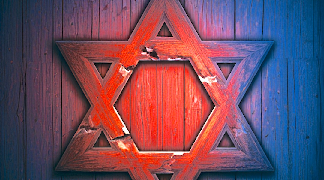 a wooden star of david illuminated by red and blue light