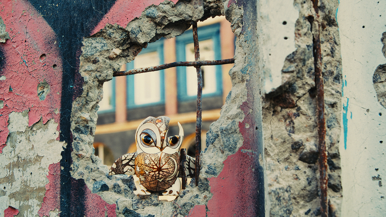 A porcelain owl made by Ukrainian artists Anya Stasenko and Stava Leontyev sits in a crumbling wall in "Porcelain War." (Picturehouse 2024)