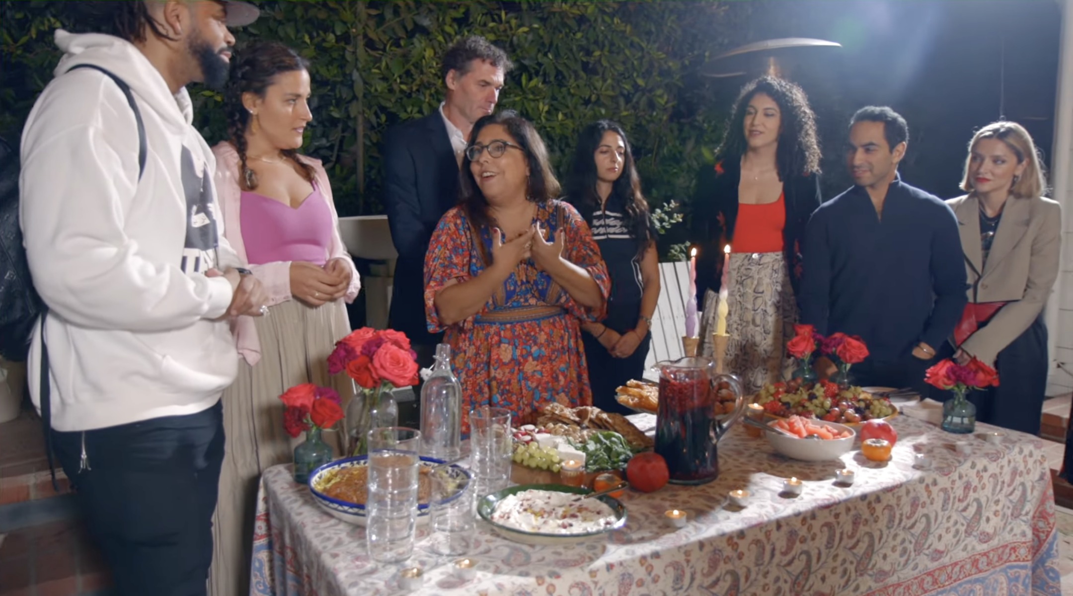 Tannaz Sassooni shows off an Erev Yalda spread in Los Angeles in December 2023. Rachel Sumekh, her collaborator, stands at the back wearing red. (Screenshot)