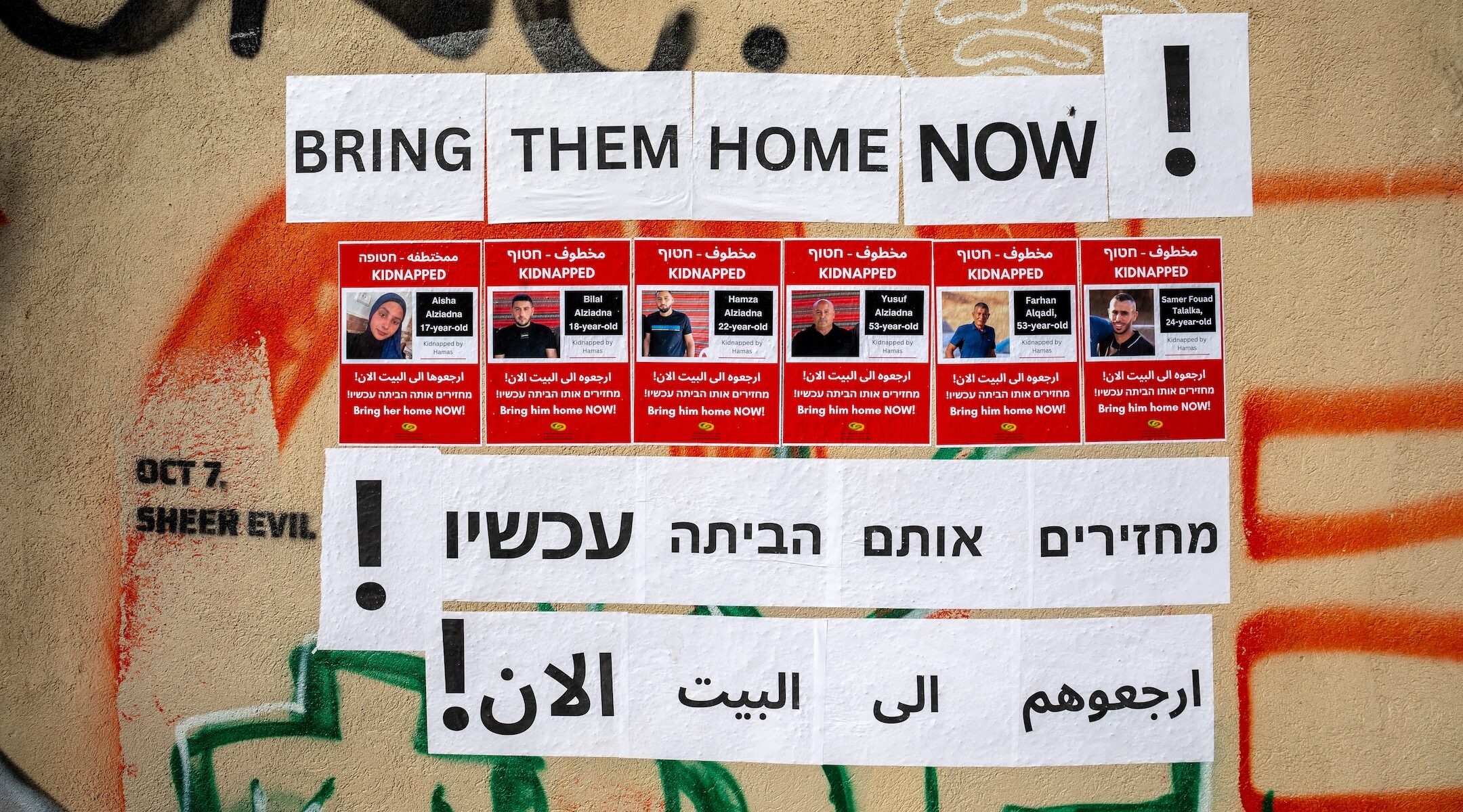 Posters calling for the return of four members of the Bedouin Ziyadne family, who were kidnapped on Oct. 7, 2023, were written in Hebrew, English and Arabic and hung in the center of Tel Aviv, Nov. 30, 2023. (Yahel Gazit / Middle East Images / via AFP/Getty Images)