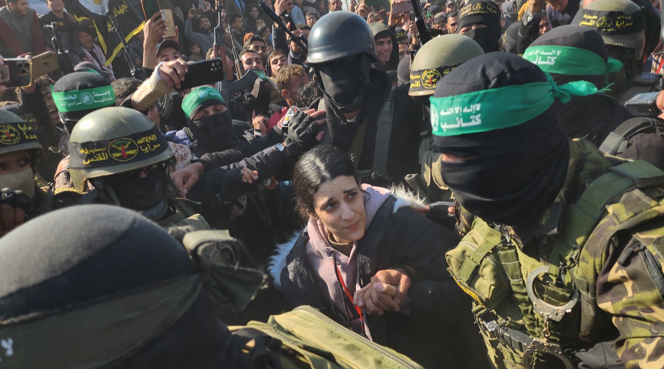 Arbel Yehud, an Israeli hostage held in Gaza, is made to traverse a dense crowd of terrorists before being handed over to the Red Cross outside Yahya Sinwar's house in Khan Younis, Gaza, Jan. 30, 2025. (Hani Alshaer/Anadolu via Getty Images)