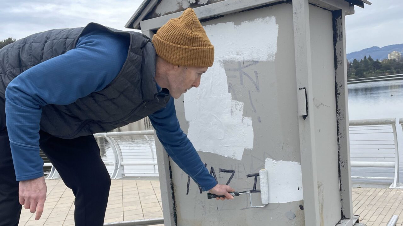 Man paints over graffiti