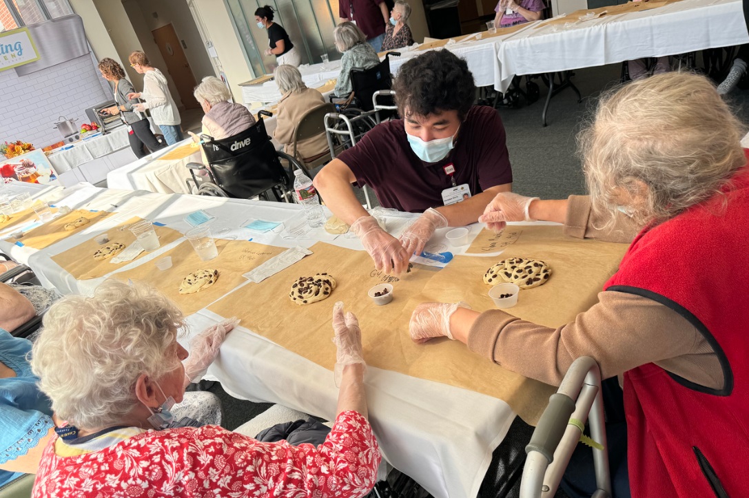 Residents and a staff member at the San Francisco Campus for Jewish Living make challah during High Holidays 2024. (Courtesy)