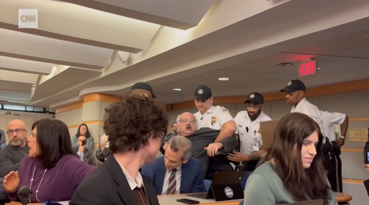 Man pulled away by police