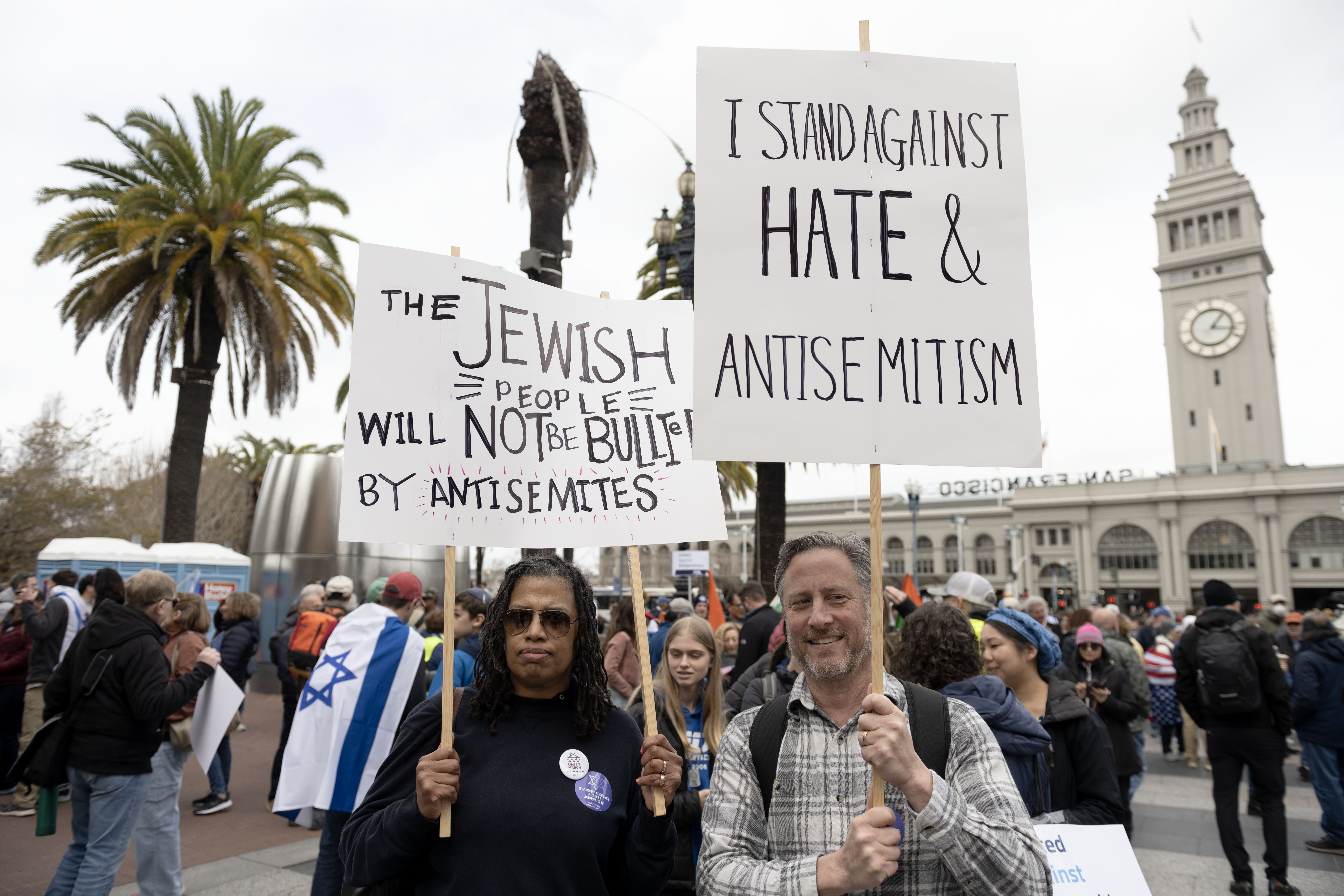 Michele Berry (left) and Ken Bravmann stand in Embarcadero Plaza during a Jewish Unity March against antisemitism in San Francisco on Sunday, March 3, 2024. (Aaron Levy-Wolins/J. Staff)