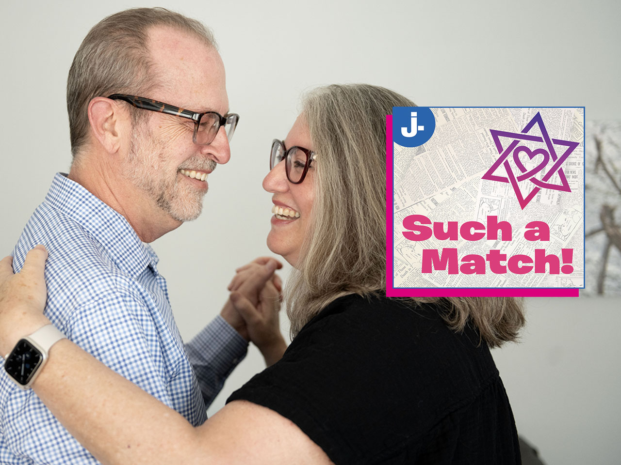 a middle aged man and woman smile as they embrace