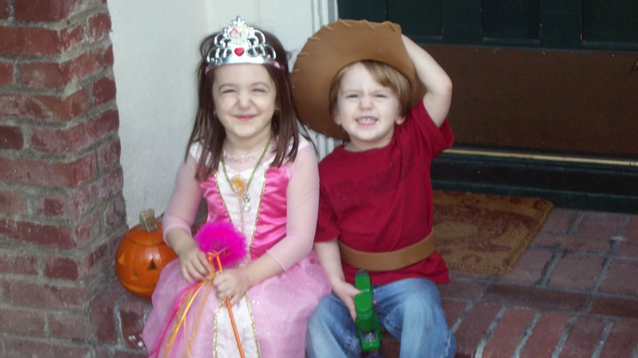 The author's kids, Mira (left) and Sam, sit dressed for Halloween on the doorstep of the family's former house in Altadena. (Courtesy of Rebecca Golbert)
