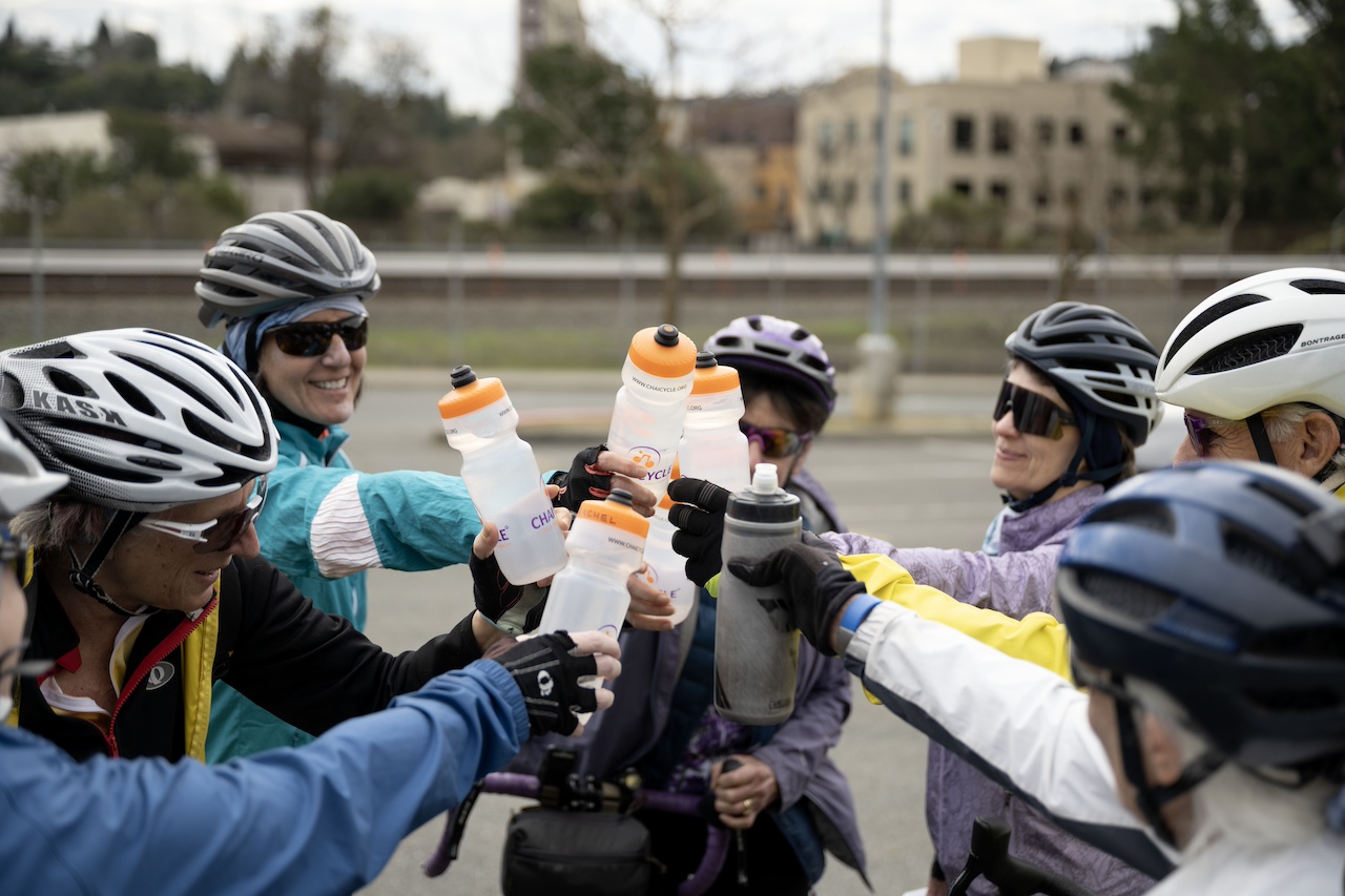 Chai Cycle, a group of local Jews who bike around the Bay Area and break for learning Torah and Talmud, put their branded water bottles together outside the Orinda BART Station on Feb. 23, 2025. (Aaron Levy-Wolins/J. Staff)