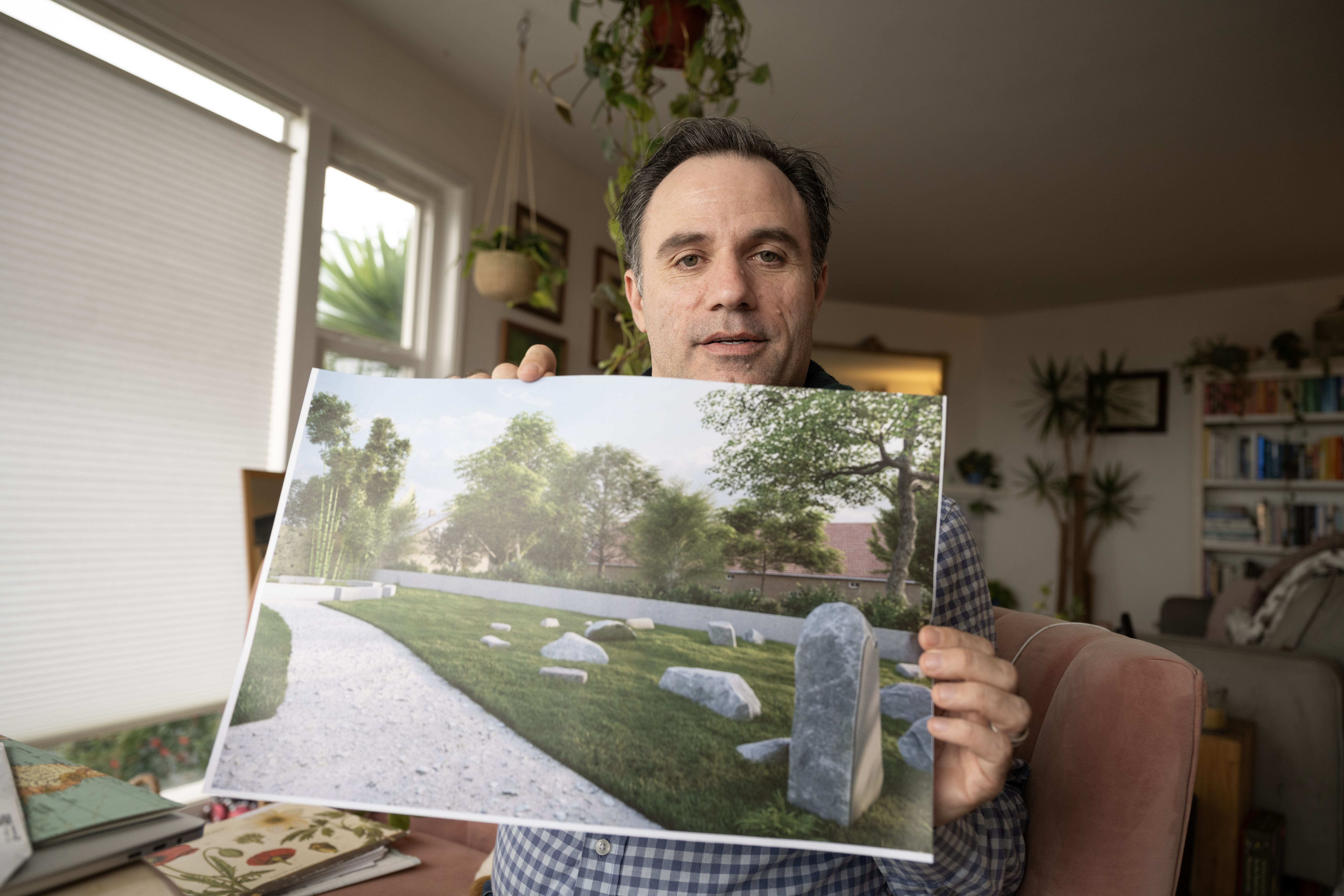 Ben Wood shows a reimagined Jewish graveyard where a family member was buried that was destroyed in World War II at his home in San Francisco, Feb. 14, 2025. (Aaron Levy-Wolins/J. Staff)