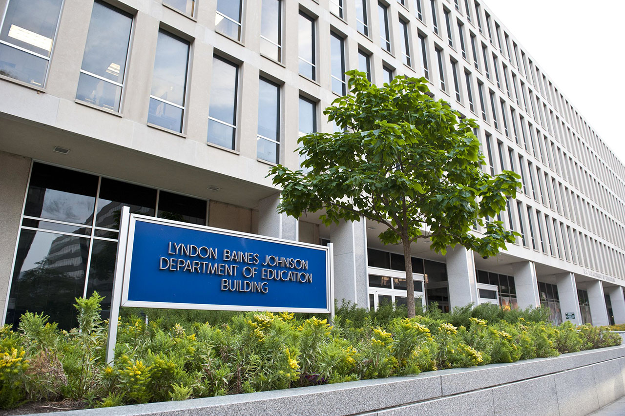 a long modern office building with a sign in front that says "Lyndon Baines Johnson Department of Education Building"