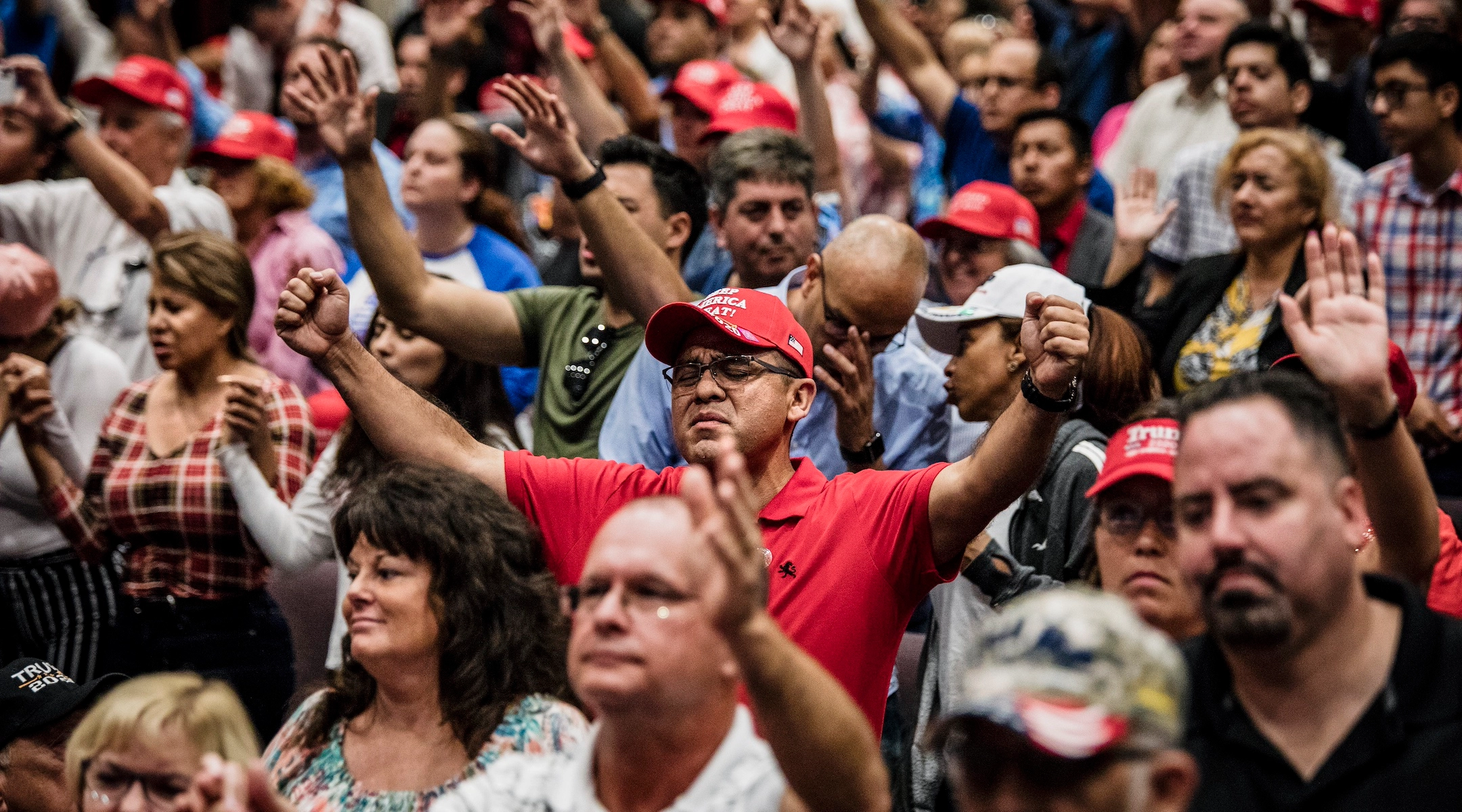 A crowd of evangelical christians praying for Trump