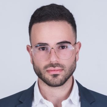 headshot of a younger man in glasses