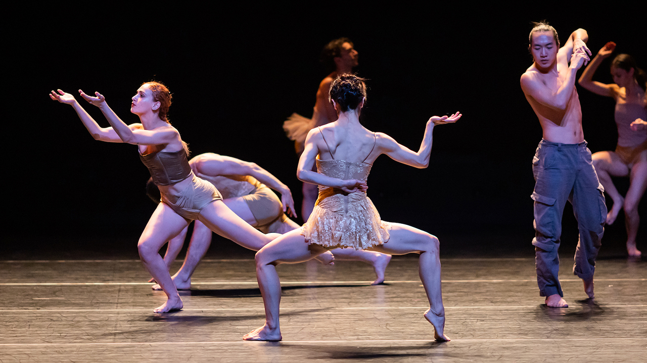 six people perform a chaotic modern dance on stage
