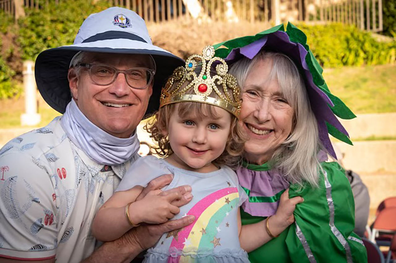 Joanne Greene and husband Fred with their granddaughter on Purim in 2022.
