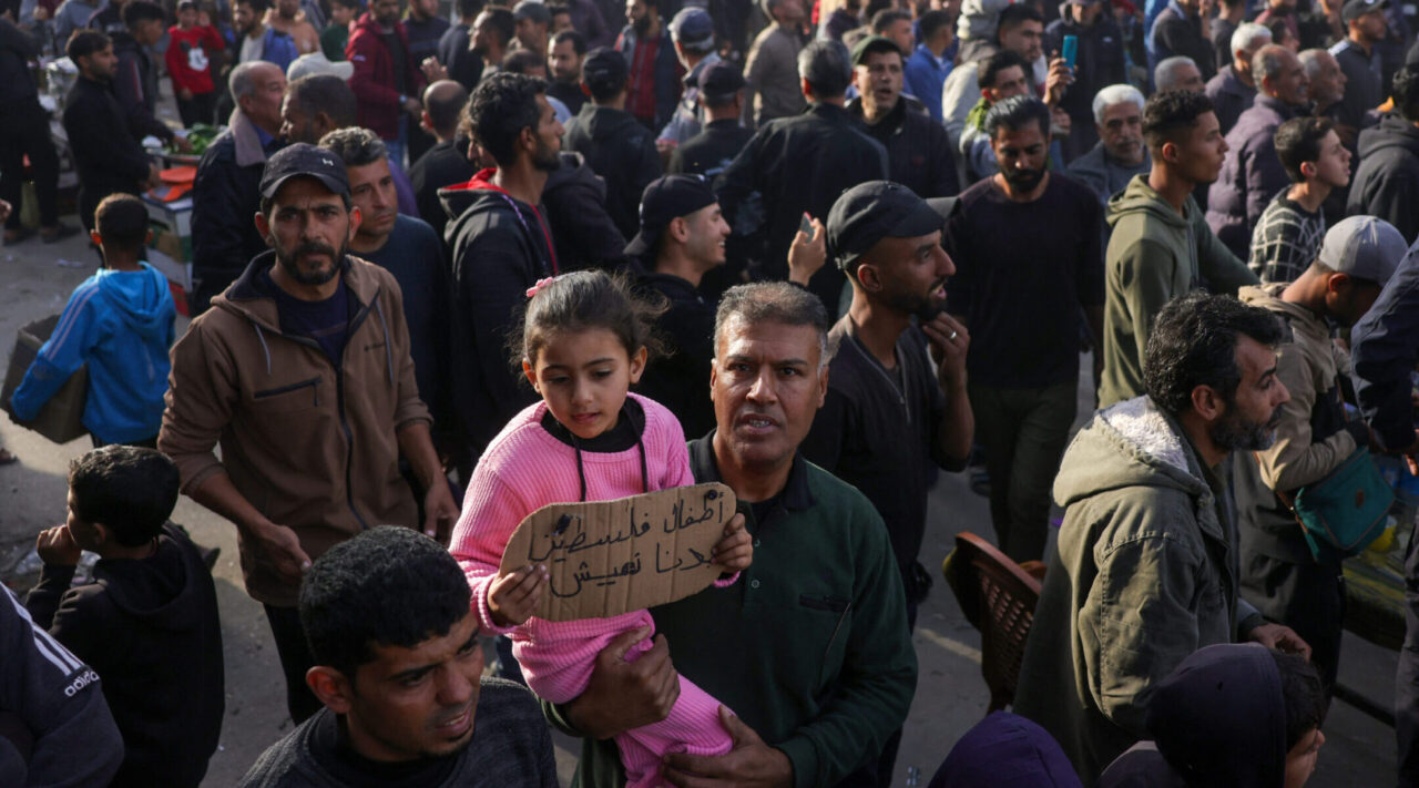 A child carries a sign reading in Arabic: "The children of Palestine: We want to live" during a rally calling for an end to the war, in Beit Lahia, in the northern Gaza Strip, on March 25, 2025.  (AFP via Getty Images)