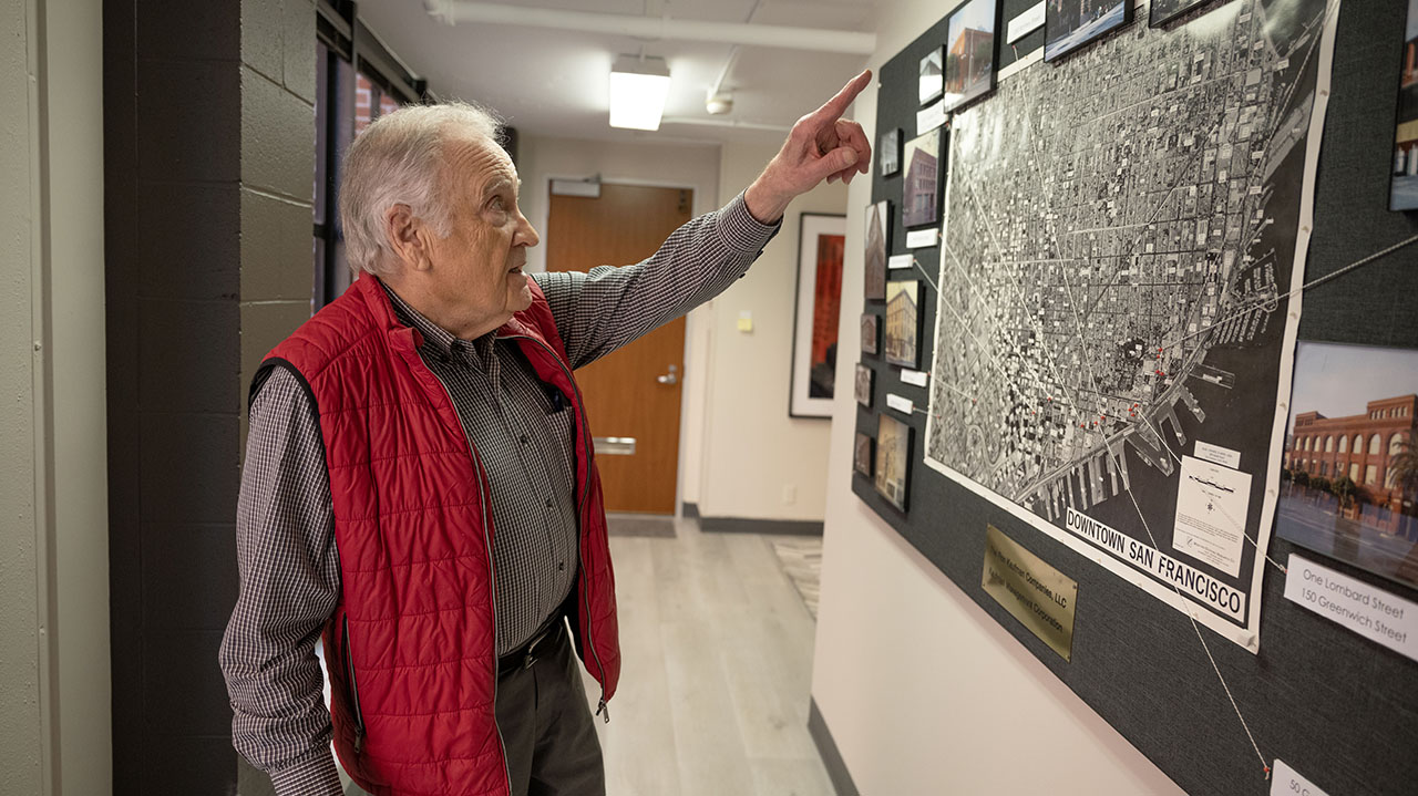 Ron Kaufman, whose company specializes in the preservation of historic buildings, points to a map of the various properties he’s helped recover and preserve at his office in San Francisco on April 3, 2025. (Aaron Levy-Wolins/J. Staff)