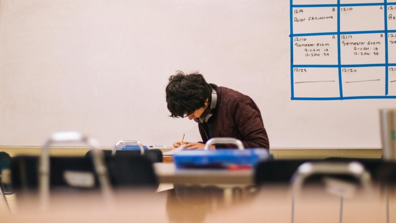 man writing on table