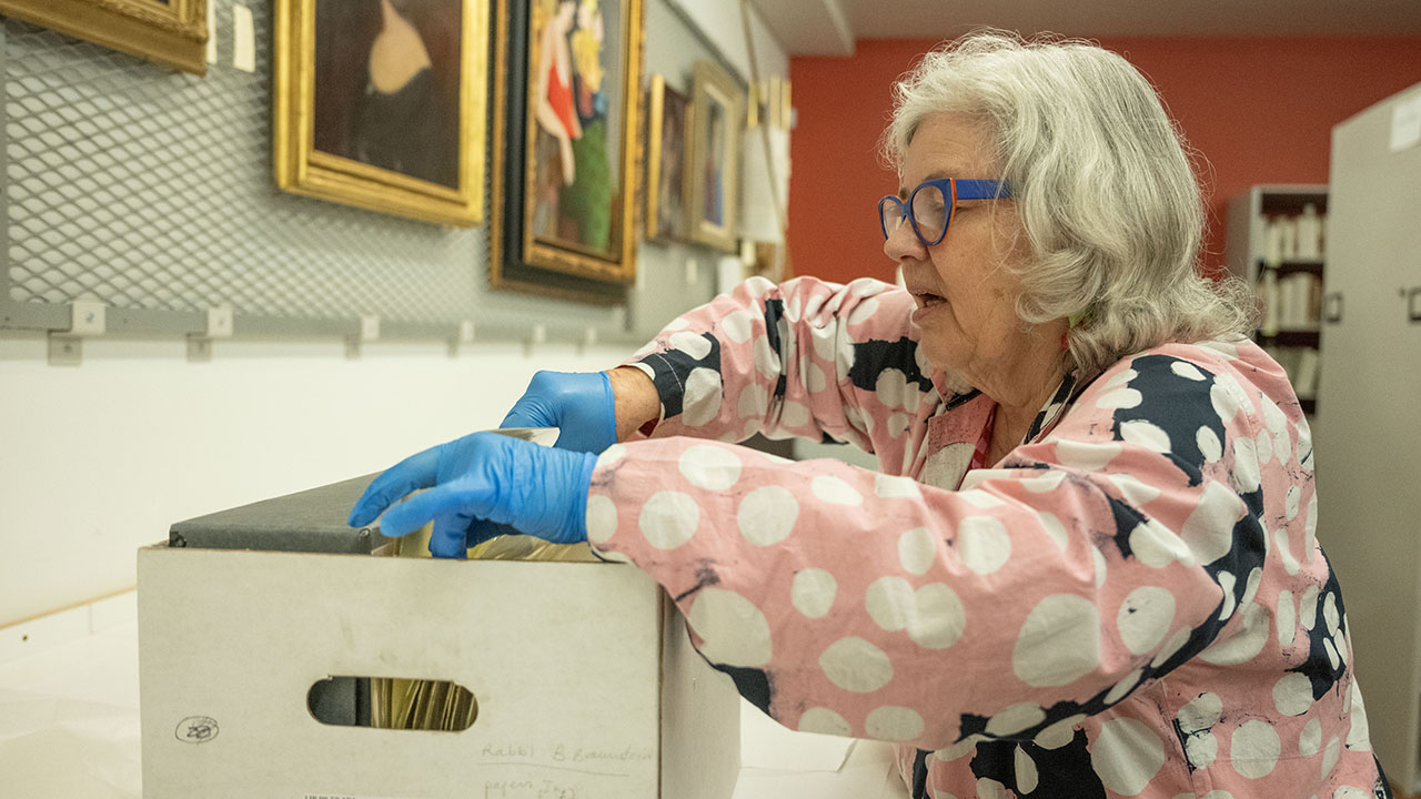 Julie Franklin, registrar and rights and reproductions manager at The Magnes, looks through a box containing documents from the Spanish Inquisition in the documents archive room of The Magnes Collection of Jewish Art and Life in Berkeley, April 22, 2025. (Aaron Levy-Wolins/J. Staff)