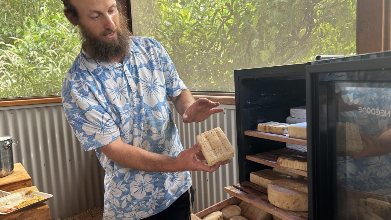 Man holds block of cheese