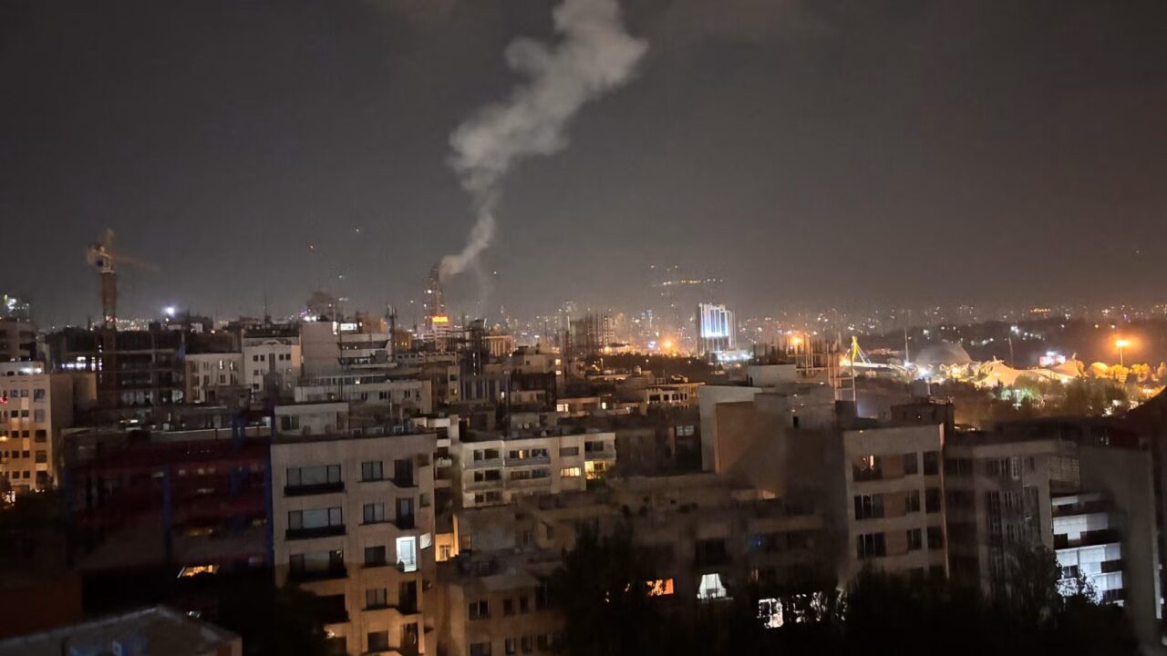 smoke rises from night sky