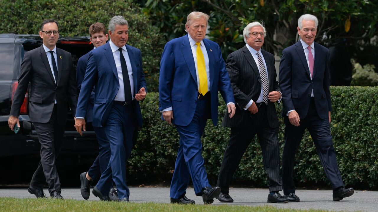 President Donald Trump is accompanied by newly appointed U.S. Ambassador to France Charles Kushner (right) and other guests as they head for a flag-raising ceremony for a newly installed flag pole on the South Lawn of the White House on June 18. (Chip Somodevilla/Getty Images)