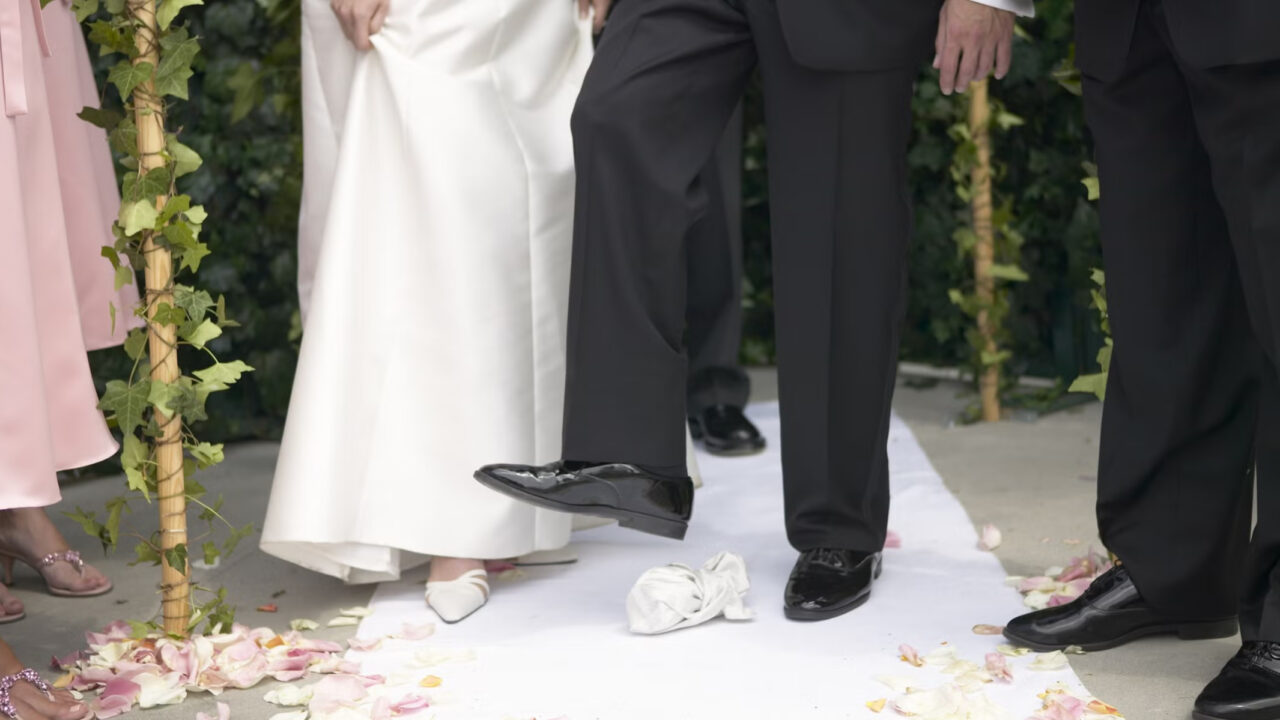 Groom crushes glass in Jewish wedding ceremony.