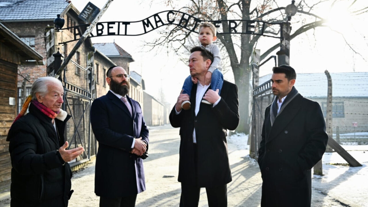 Elon Musk and others visiting Auschwitz