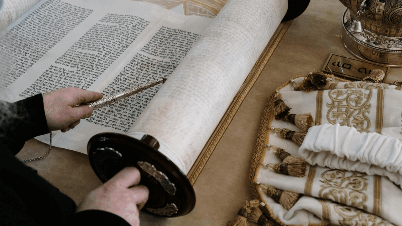 Person reading a Torah scroll