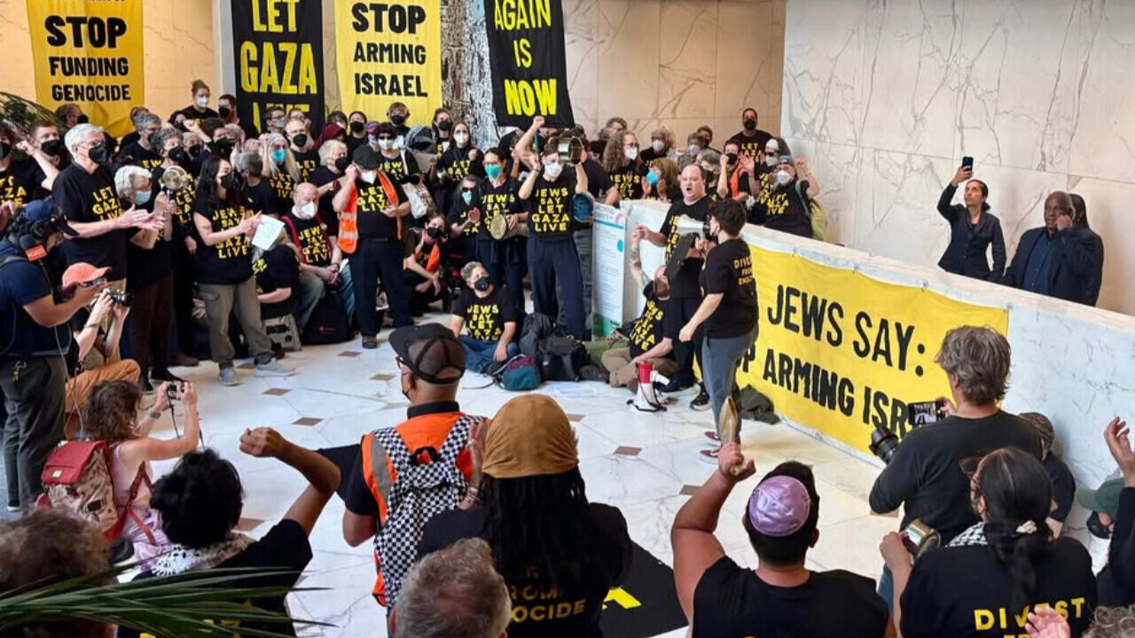 Jewish Voice for Peace protesters wear face masks and hold signs in lobby of Sen. Alix Padilla's S.F. office