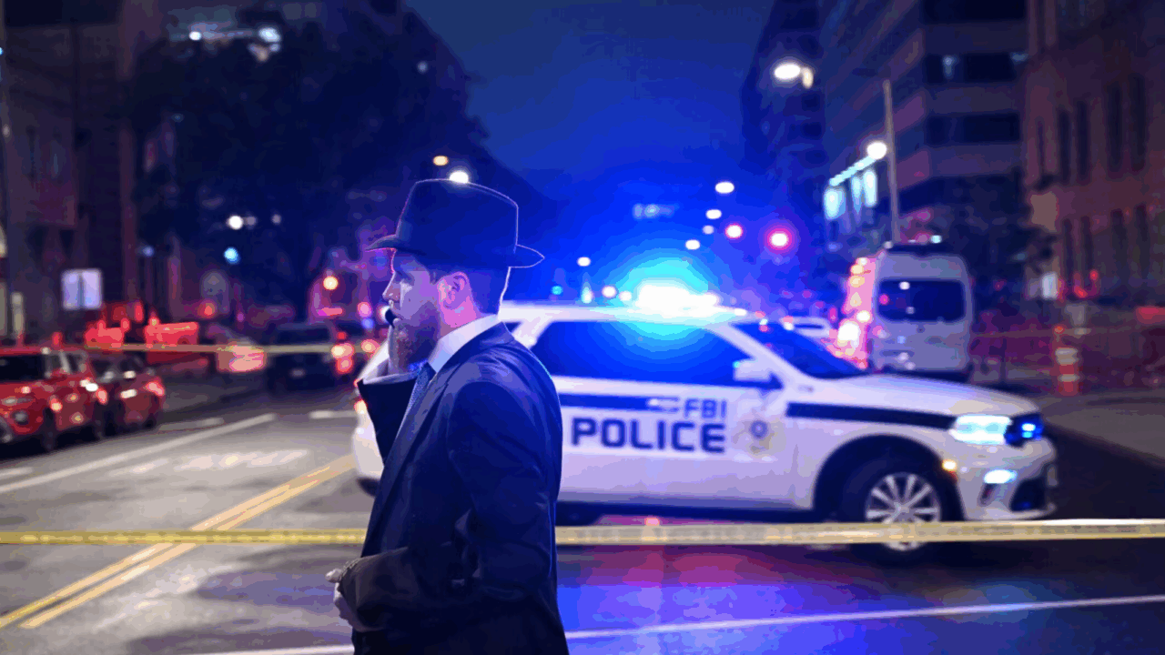 Man talking on phone in front of police car