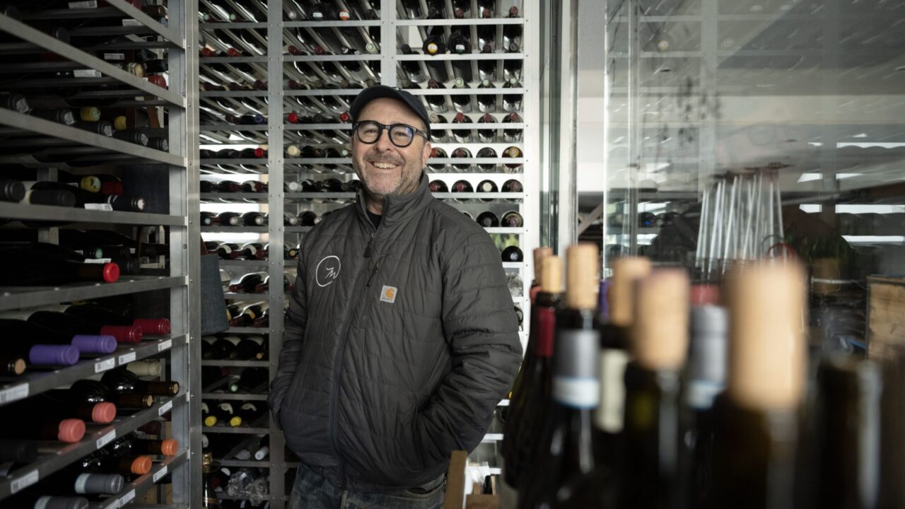 Paul Einbund stands amid the wine racks