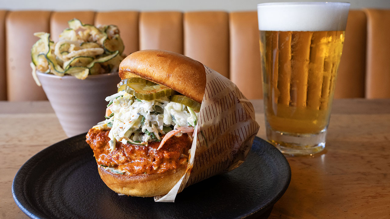 This Roam meal features a zucchini and onion haystack, a spicy fried chicken sandwich and a beer. (Aaron Levy-Wolins/J. Staff)