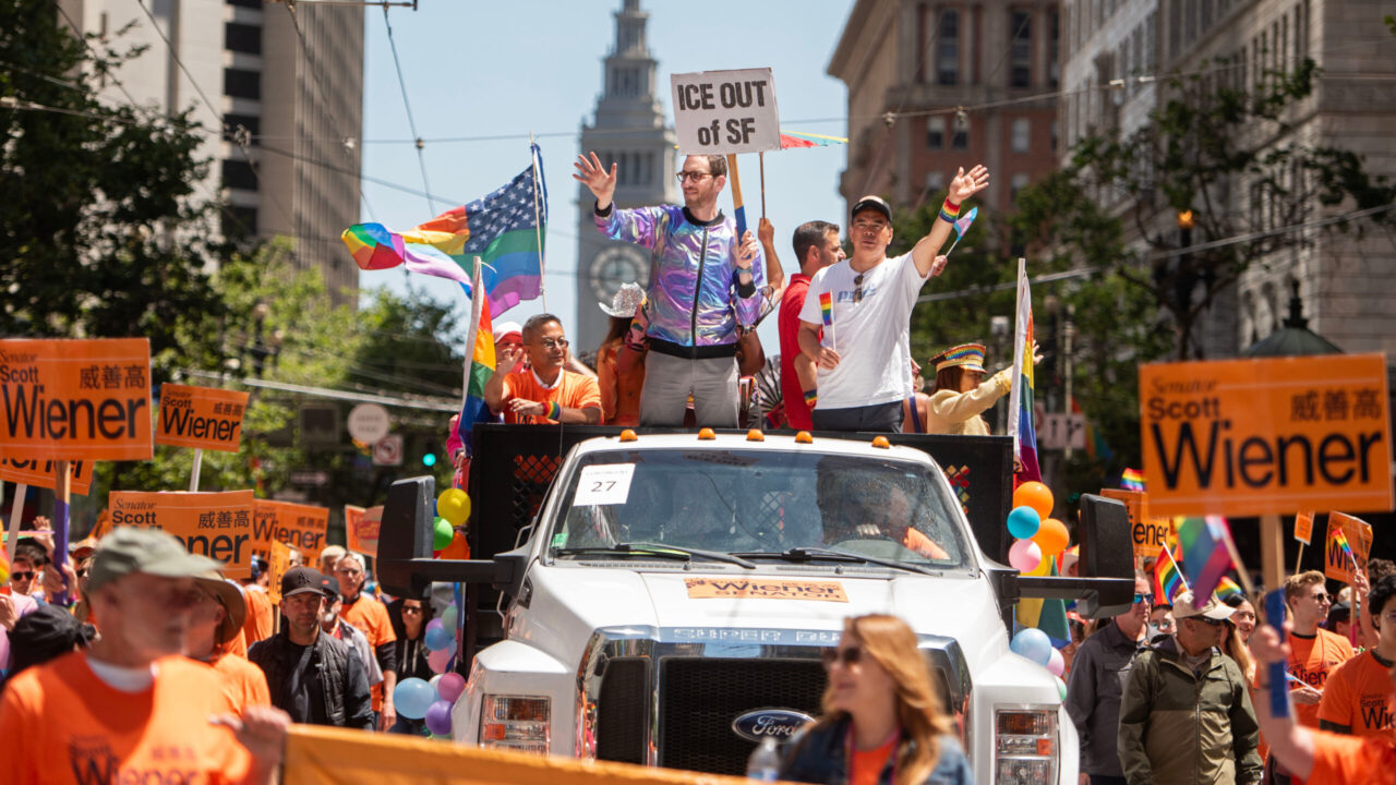 State Sen. Scott Wiener waves to the crowd while holding a sign that reads “ICE out of SF,” referring to Immigration and Customs Enforcement, during the San Francisco LGBTQ Pride Parade on June 29, 2025. (Aaron Levy-Wolins/J. Staff)