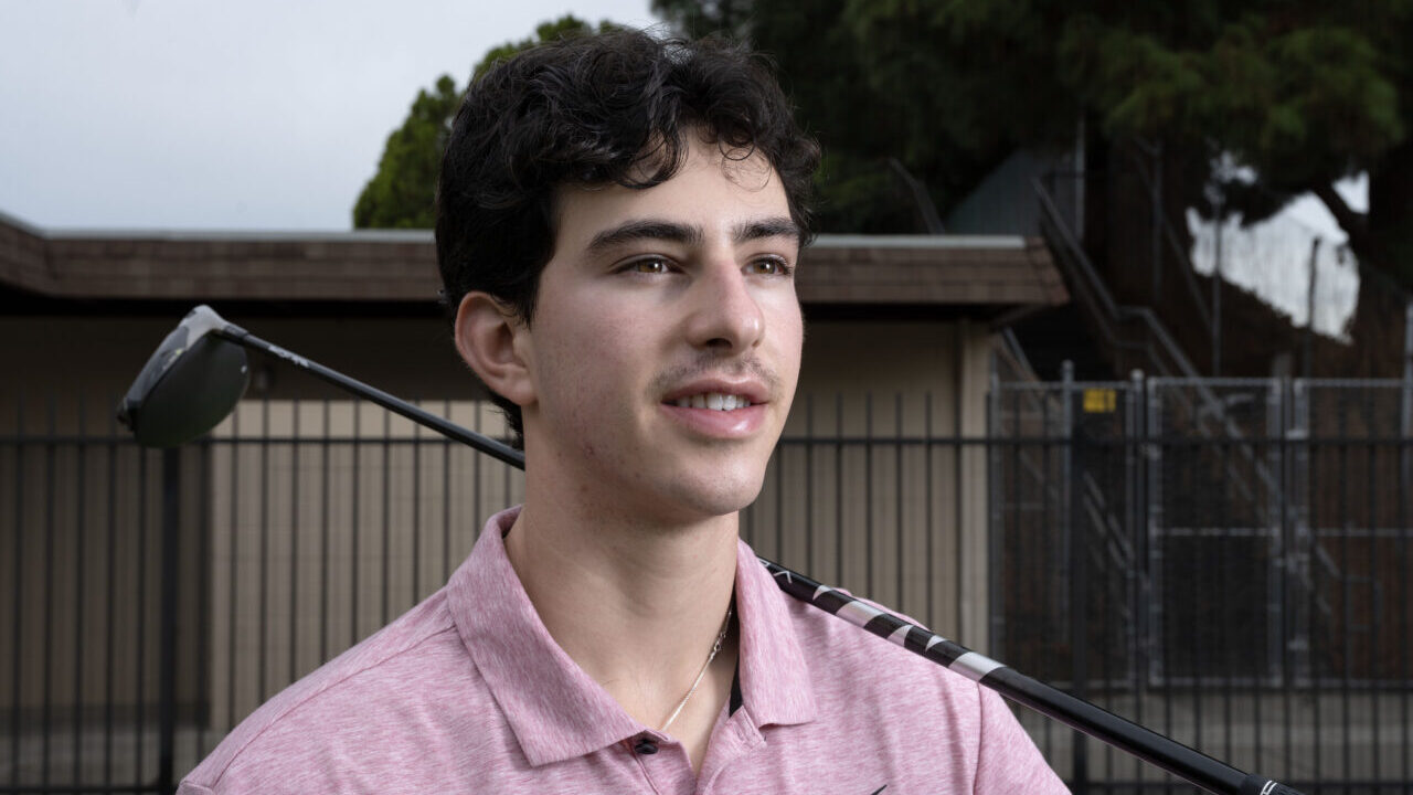 Young man holding a golf club