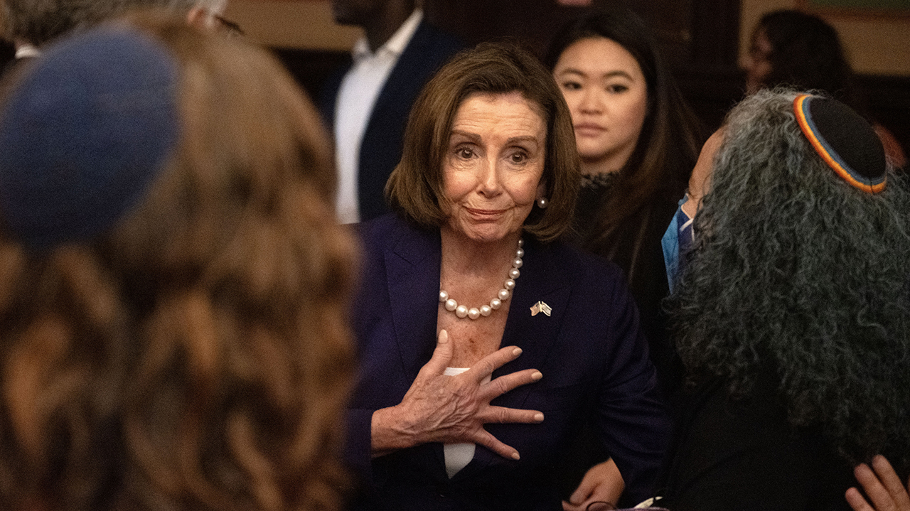 Rep. Nancy Pelosi clutches her chest in sympathy during a community gathering at Congregation Sherith Israel in San Francisco, one day after the Oct. 7, 2023, attack on Israel. (Aaron Levy-Wolins/J. Staff)
