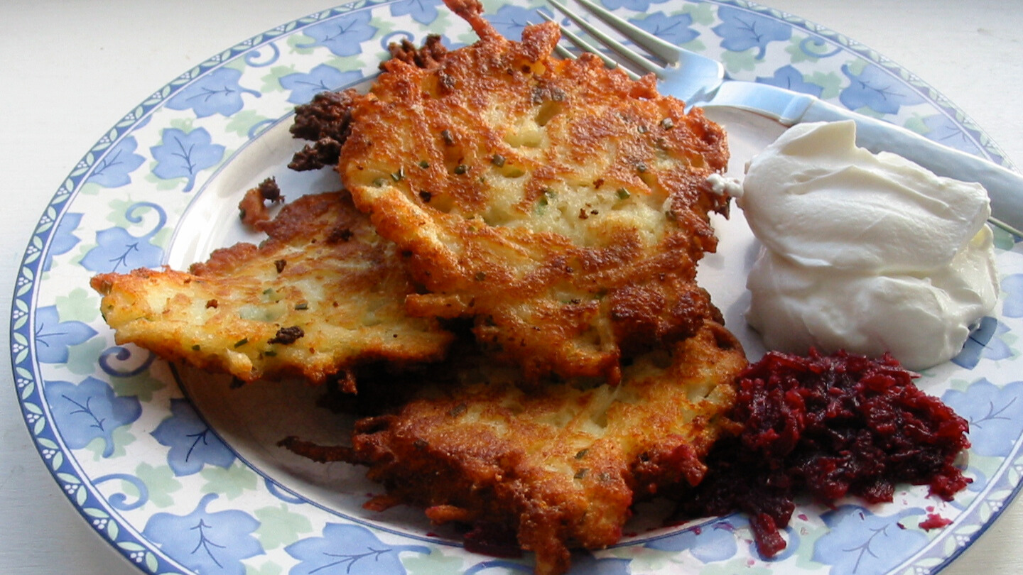 Latkes with sour cream and shredded beets.