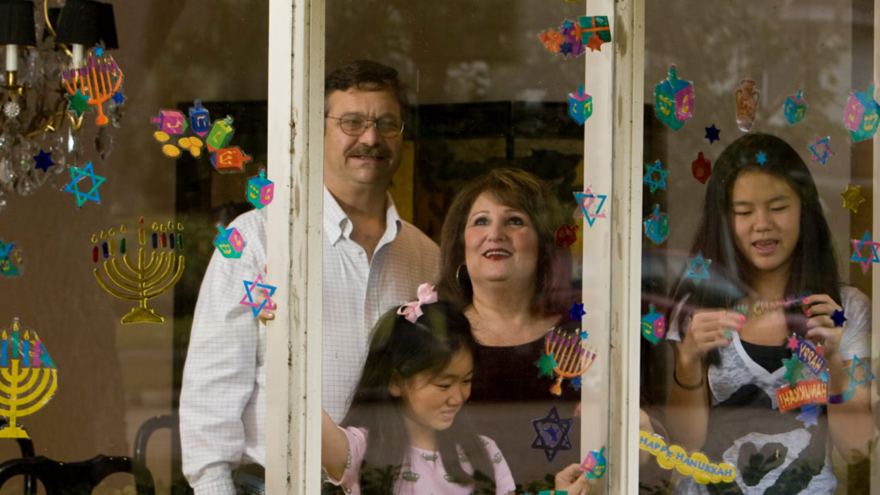 A Jewish family decorates their windows