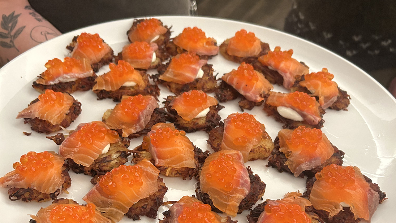 Latkes with housemade gravlax and salmon roe were served during the Berkeley Supper Club's Hanukkah party at Urban Adamah, Dec. 21, 2025. (Alix Wall)