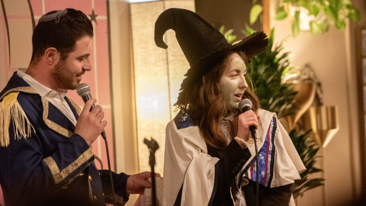 Rabbis Noah Westreich and Rena Singer followed the “Wicked” theme for a Purim event, hosted by Congregation Emanu-El at Manny’s in San Francisco in March 2025. (Aaron Levy-Wolins/J. Staff)