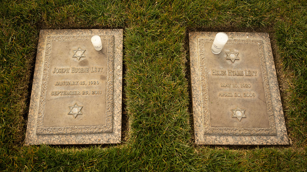 Two headstones with candles on them, seen from above